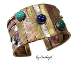 Mixed media cuff bracelet with malachite, lapis and turquoise stones set atop textured and antiqued copper, sterling and brass