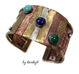Mixed media cuff bracelet with malachite, lapis and turquoise stones set atop textured and antiqued copper, sterling and brass