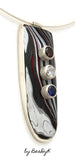 Pendant with Corvette Fordite cabochon set in sterling silver and set with red, white and blue cubic zirconias by BeaDyK.