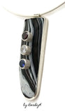 Pendant with Corvette Fordite cabochon set in sterling silver and set with red, white and blue cubic zirconias by BeaDyK.